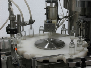 Máquina llenadora y engastadora de frascos de perfume